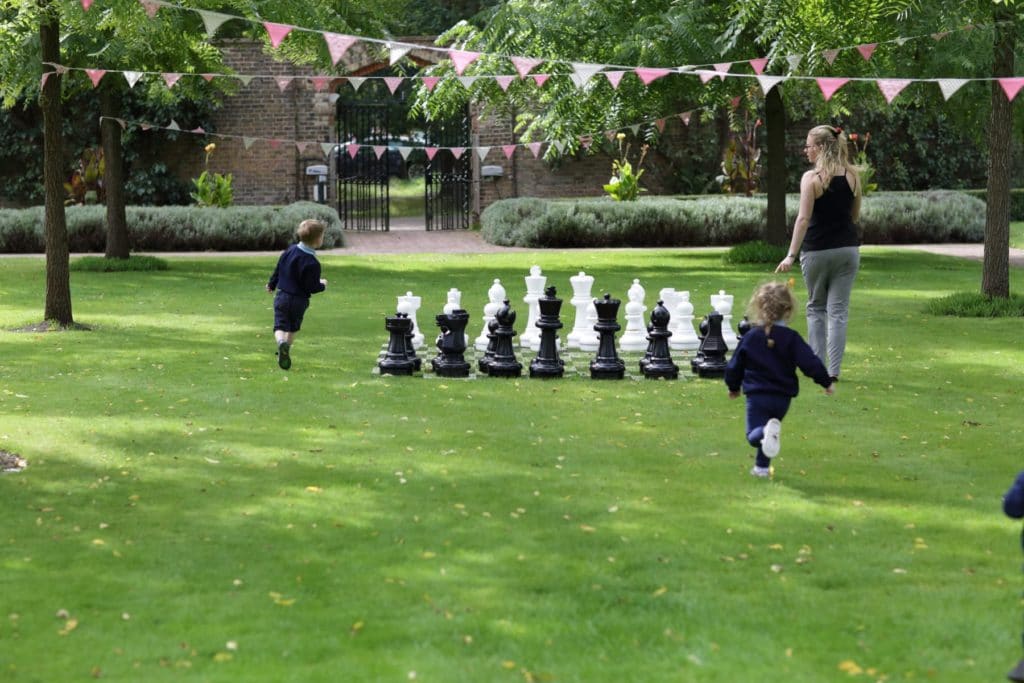 children around the giant chess set, school trips and activities at The Grove