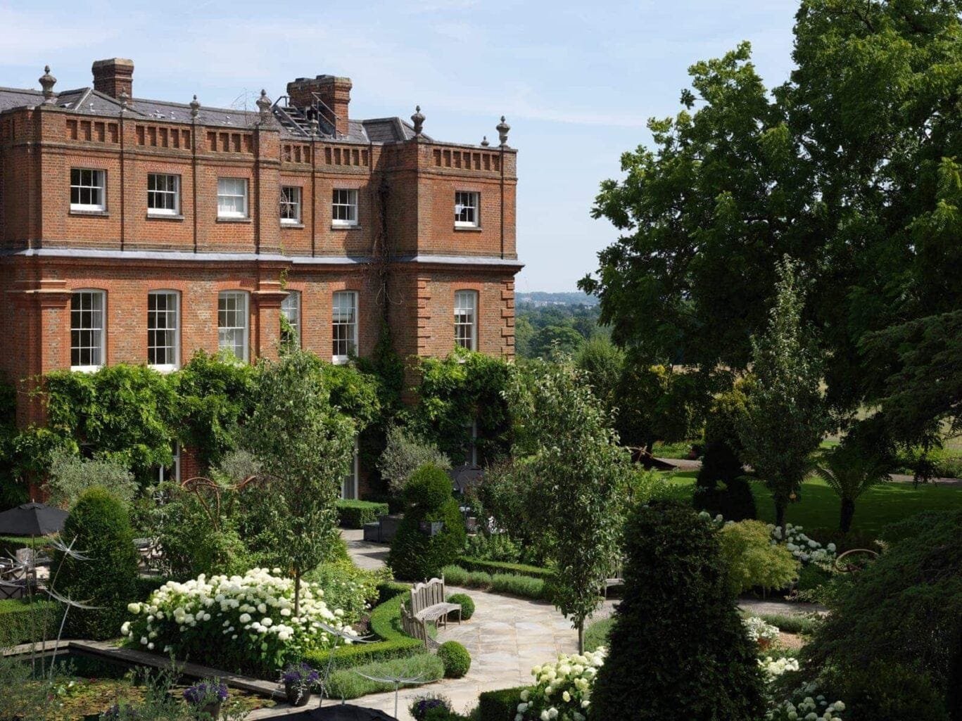 The formal gardens with the mansion in the background