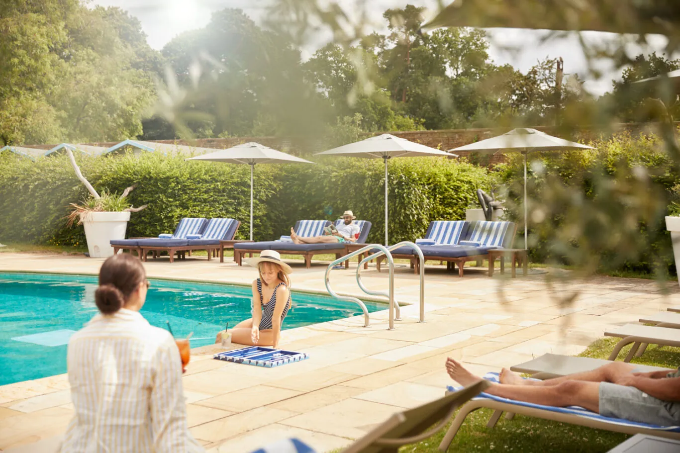 People at the outdoor pool in the walled garden at The Grove