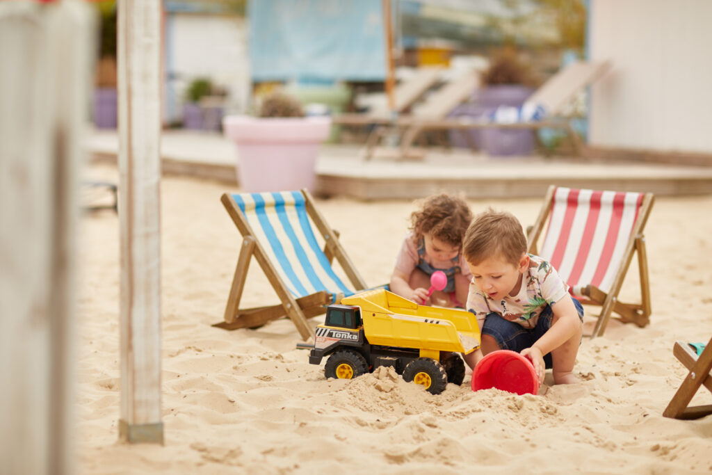 Children playing at ralphs beach in the walled garden at the Grove