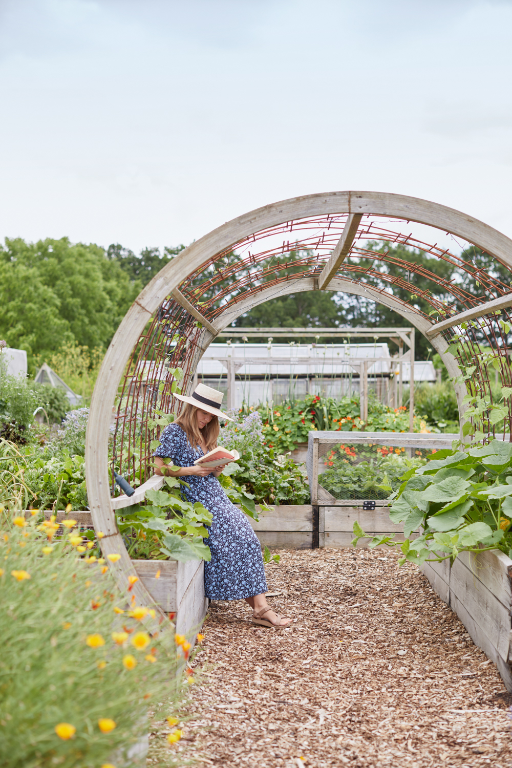 Woman reading in the walled garden at The Grove