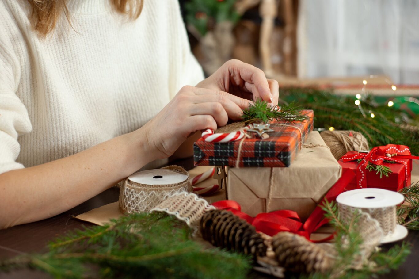 Woman wrapping up Christmas present