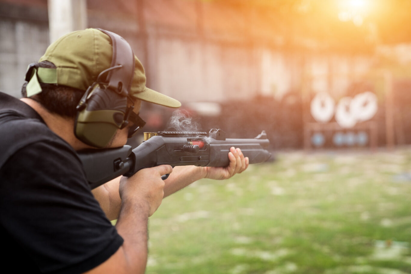 Man shooting a rifle outdoors