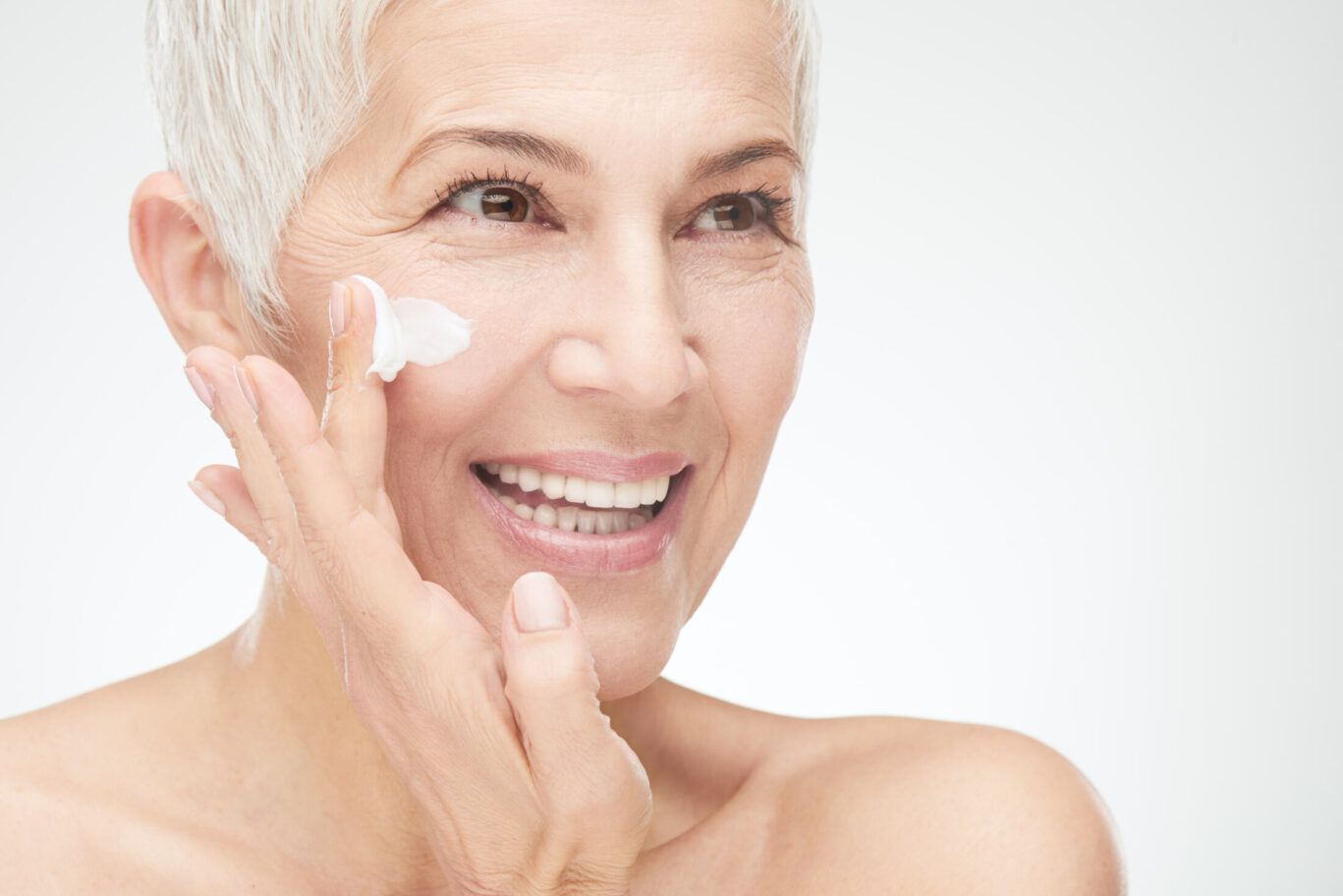 Woman applying face cream