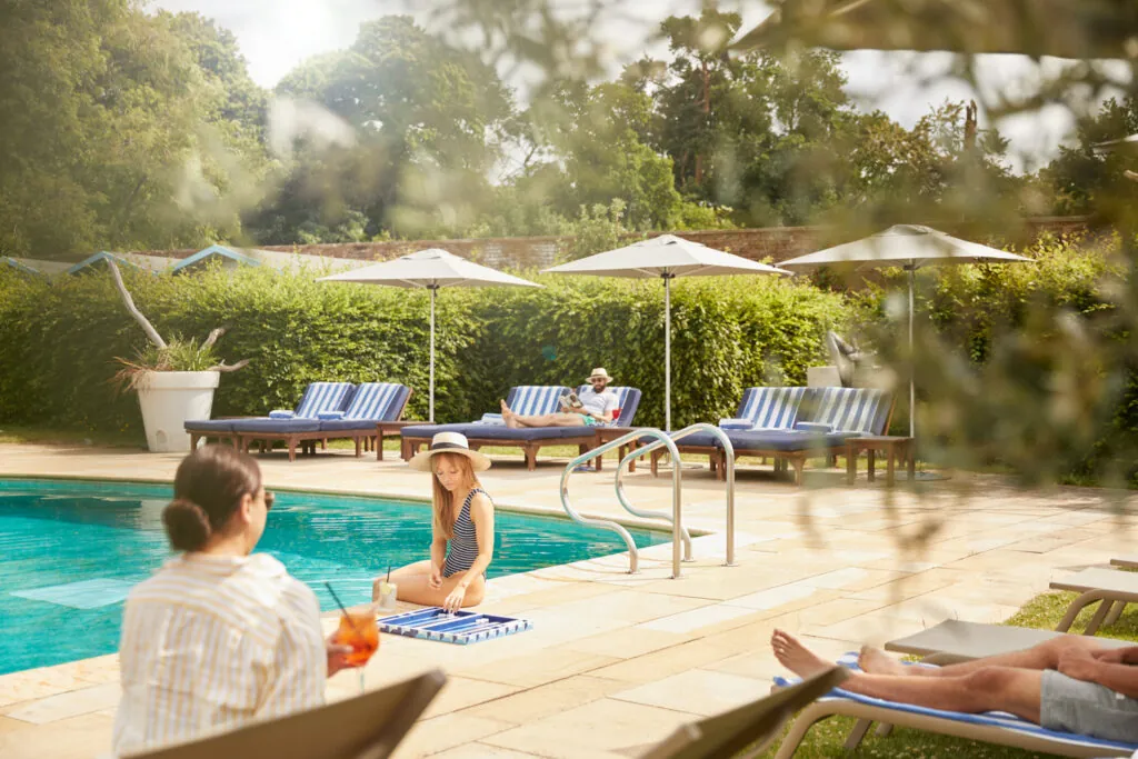 Guests relaxing by the outdoor pool