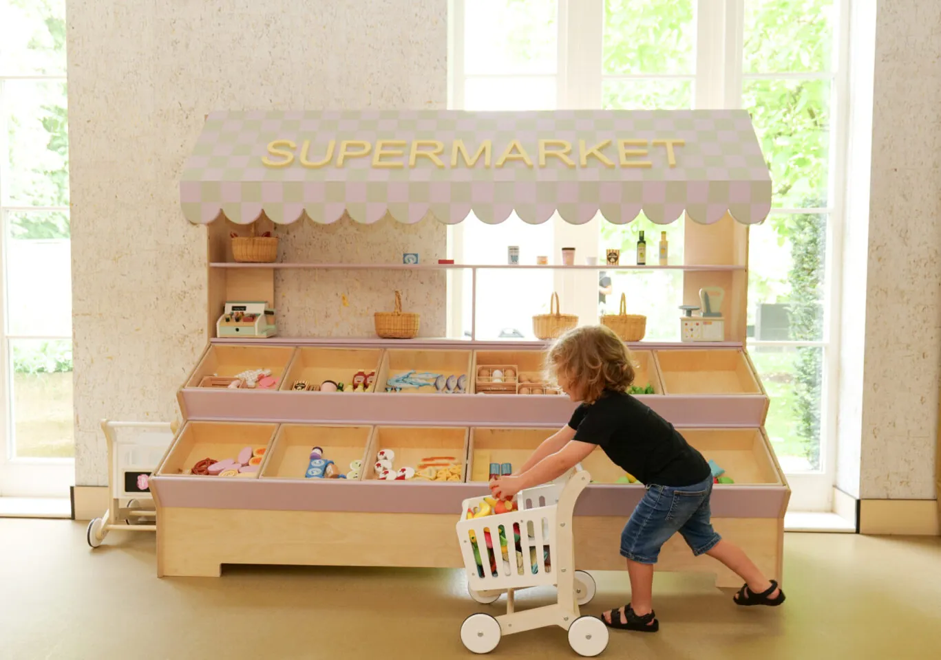 Child playing at Pocket Towns supermarket
