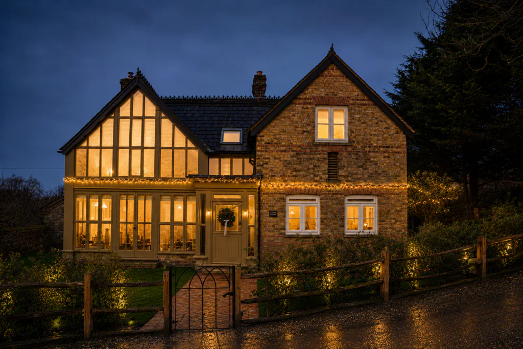 Wisteria cottage during Christmas at night.